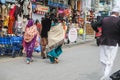 Pakistani people in traditional dress walking at the shopping street.