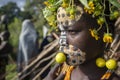 Girl from the Suri tribe poses for a photo with a traditionally painted face. Ethiopia