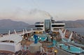 Muscat, Oman: Tourists on the open deck of cruise liner MSC Splendida near Muscat fjords Royalty Free Stock Photo