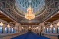 Muscat, Oman - 04.04.2018: Awe inspiring interior of Sultan Qaboos Grand Mosque in Muscat, Oman. Crystal chandelier and