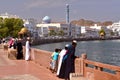 MUSCAT, OMAN - FEBRUARY 10, 2012: Muttrah corniche in Muscat with Omani young boys traditionally dressed