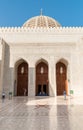 Arched gates and carved wooden doors leading to the Sultan Qaboos Grand Mosque, Muscat, Oman