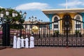 Small muslim boys in traditional kanduras standing in front of colorful Al-Alam Palace in Old Muscat, Oman