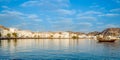 Muscat Skyline with a traditional arabic Dhow