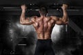 Muscle athlete man in gym making pull up Royalty Free Stock Photo