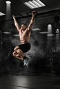 Muscle athlete man in gym making pull up Royalty Free Stock Photo