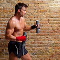 Muscle boxer man with fist bandage and weights Royalty Free Stock Photo