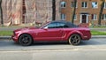 Muscle car purple red Ford Mustang convertible parked