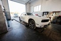 Muscle car at service repair station. Jacks up the car to diagnose the chassis