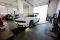 Muscle car at service repair station. Jacks up the car to diagnose the chassis