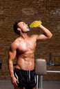 Muscle man at gym relaxed with energy drink Royalty Free Stock Photo