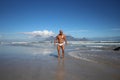 Muscle man in white speedo against stunning and classic view of Table Mountain