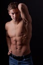 Muscle naked young man posing in jeans