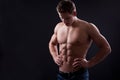 Muscle naked young man posing in jeans