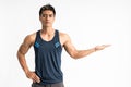 Muscle young man wearing sportswear stand facing forward look the camera with present something on his hand