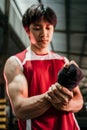 muscled asian fighter wearing black strap on wrist