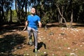 Muscled man doing workout run in place exercise in forest. Handsome sportsman wearing sportswear is running in place exercise.