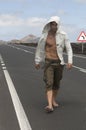Muscled man walking on the road Royalty Free Stock Photo