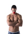 Muscled Young Man with Red Ball as Clown Nose, sad Royalty Free Stock Photo