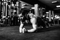 Muscled young man wearing sport wear and doing plank position while exercising on the floor in loft interior Royalty Free Stock Photo