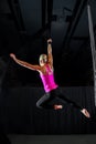 Muscular Aerialist In An Arabesque Pose From a Belay Loop Royalty Free Stock Photo