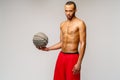 Muscular african american sportsman playing basketball shitless over light grey background Royalty Free Stock Photo