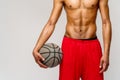 Muscular african american sportsman playing basketball shitless over light grey background Royalty Free Stock Photo