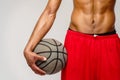 Muscular african american sportsman playing basketball shitless over light grey background Royalty Free Stock Photo