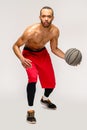 Muscular african american sportsman playing basketball shitless over light grey background Royalty Free Stock Photo