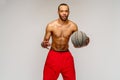 Muscular african american sportsman playing basketball shitless over light grey background Royalty Free Stock Photo