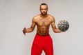 Muscular african american sportsman playing basketball shitless over light grey background Royalty Free Stock Photo