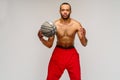 Muscular african american sportsman playing basketball shitless over light grey background Royalty Free Stock Photo