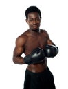 Muscular african boxer posing in style