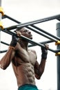 Muscular african man doing push ups in the park. Strong male athlete working out outdoors. Royalty Free Stock Photo