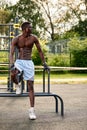 Muscular african man doing push ups in the park. Strong male athlete working out outdoors. Royalty Free Stock Photo