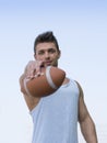 Muscular american football with ball in hand. Royalty Free Stock Photo