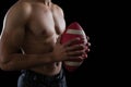 Muscular American football player holding a football in his hand Royalty Free Stock Photo