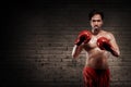 Muscular asian boxer with red gloves