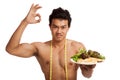 Muscular Asian man diet with clean food and measuring tape Royalty Free Stock Photo