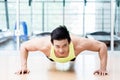 Muscular Asian man doing pushups in gym Royalty Free Stock Photo