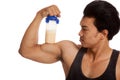 Muscular Asian man flexing biceps with whey protein shakes Royalty Free Stock Photo