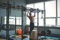 Muscular athlete man making Pull-up in gym. Bodybuilder training in fitness club showing his perfect back and shoulder Royalty Free Stock Photo