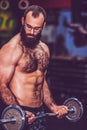 Muscular bearded fitness man workout with barbell in gym Royalty Free Stock Photo