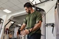 Muscular bearded handsome guy doing chest cable crossover exercise Royalty Free Stock Photo