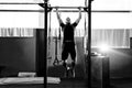Muscular bearded man training his biceps and back in gym. Pull-ups. Workout lifestyle concept. Royalty Free Stock Photo