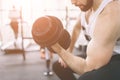 Muscular Bearded man during workout in the gym. Athlete muscular bodybuilder in the gym training biceps with dumbbell Royalty Free Stock Photo