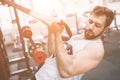 Muscular Bearded man during workout in the gym. Royalty Free Stock Photo