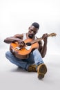 Muscular black man playing guitar