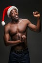 Muscular black shirtless young man in Santa Claus hat Royalty Free Stock Photo