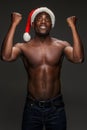 Muscular black shirtless young man in Santa Claus hat Royalty Free Stock Photo